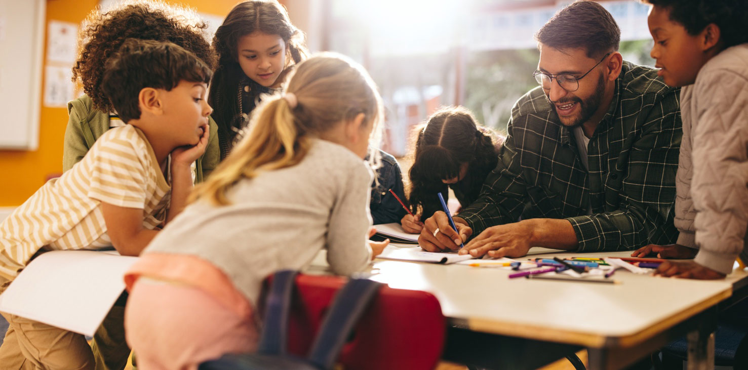 Students surrounding a table drawing