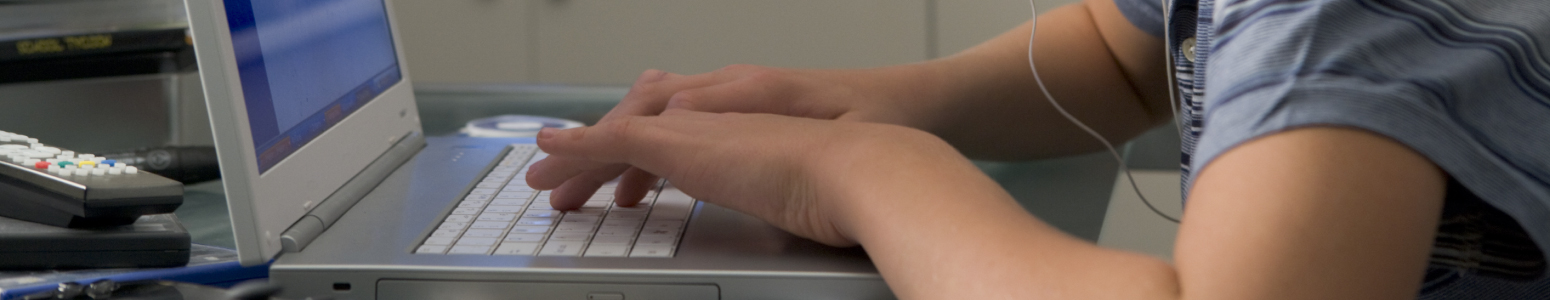 Student typing on a laptop